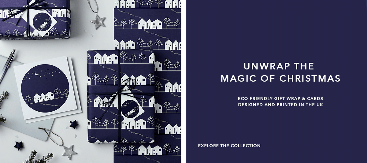 Navy blue and white eco friendly Christmas wrapping paper printed with a winter scene